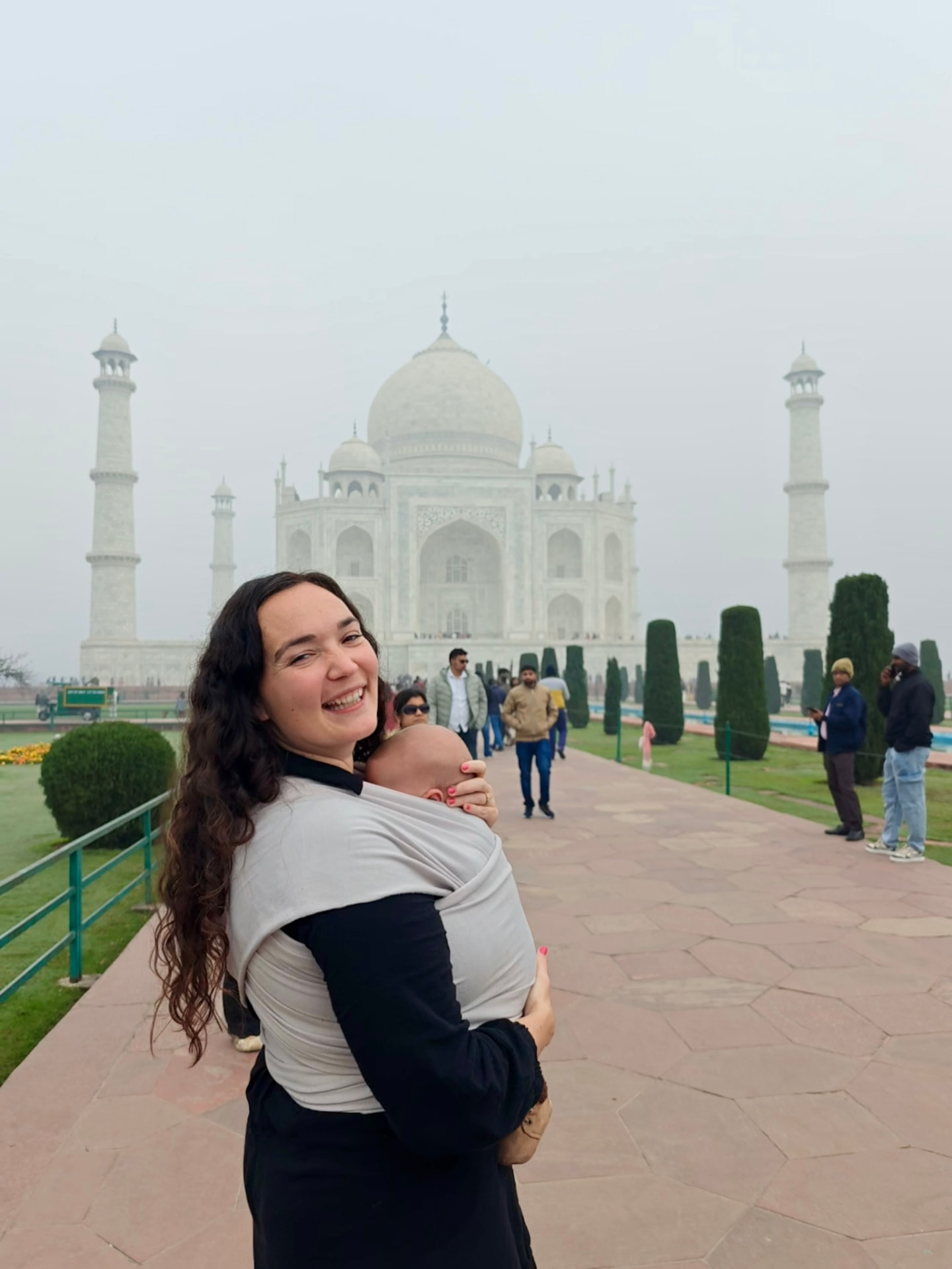 Megan smiling while babywearing at the Taj Mahal